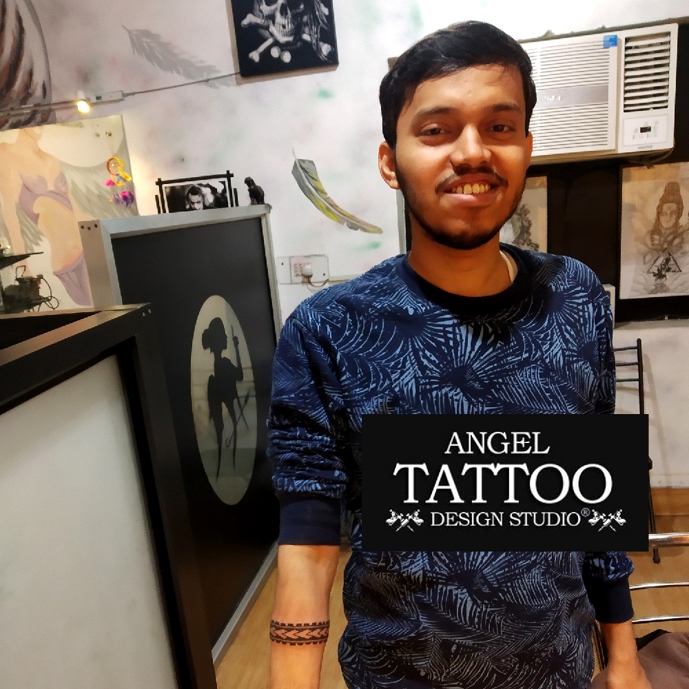 Premium Photo | Tattooed Wrist with Cross Tattoo and Religious Bracelet